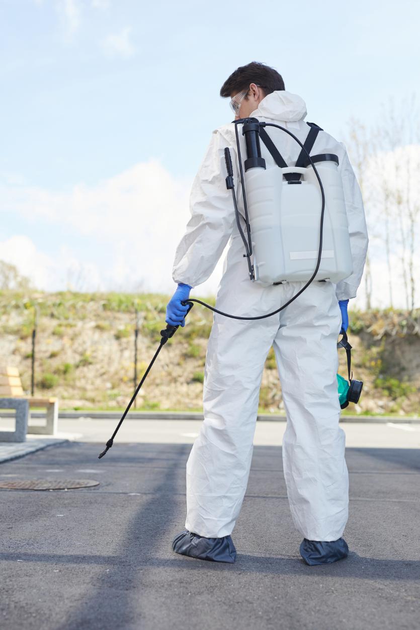 Professional pest control technician with equipment